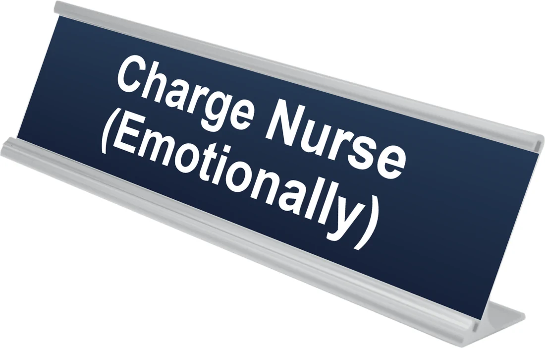 Charge Nurse (Emotionally) desk plate in navy, shown in an aluminum desk holder