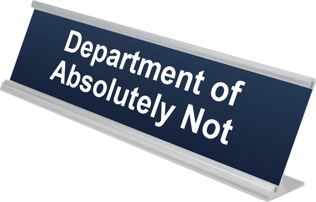 Department of Absolutely Not desk plate in navy, shown in an aluminum desk holder