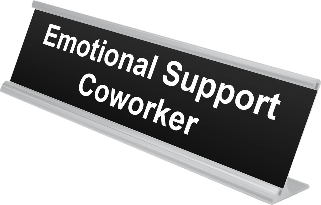 Emotional Support Coworker desk plate in black, shown in an aluminum desk holder