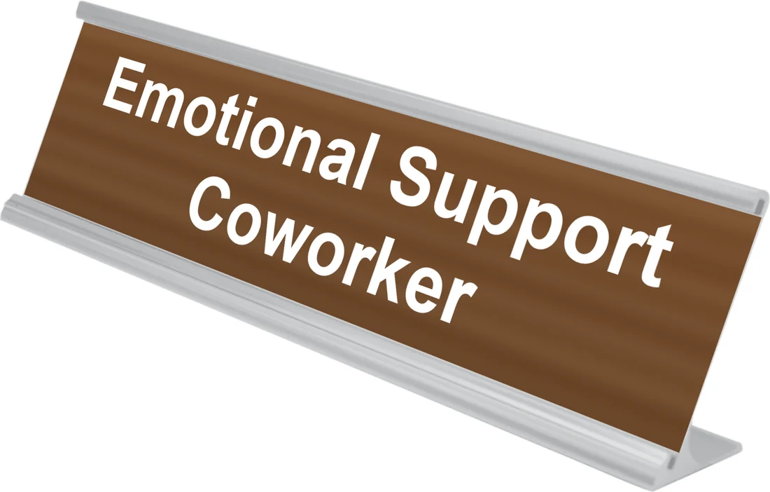 Emotional Support Coworker desk plate in walnut, shown in an aluminum desk holder