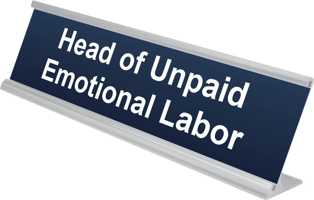 Head of Unpaid Emotional Labor desk plate in navy, shown in an aluminum desk holder