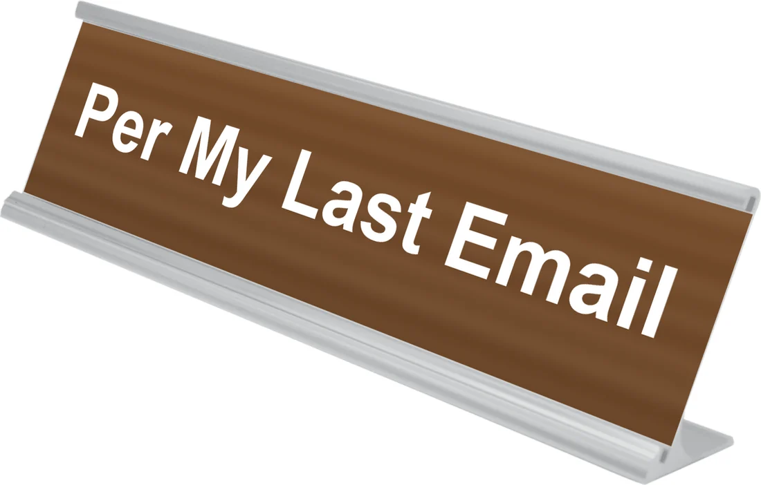 Per My Last Email desk plate in walnut, shown in an aluminum desk holder