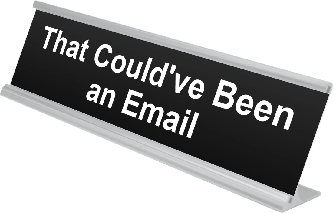 That Could've Been an Email desk plate in black, shown in an aluminum desk holder