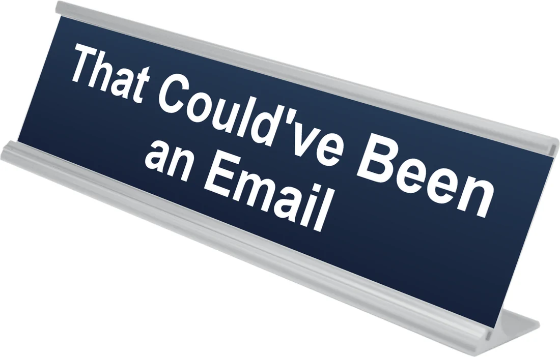 That Could've Been an Email desk plate in navy, shown in an aluminum desk holder