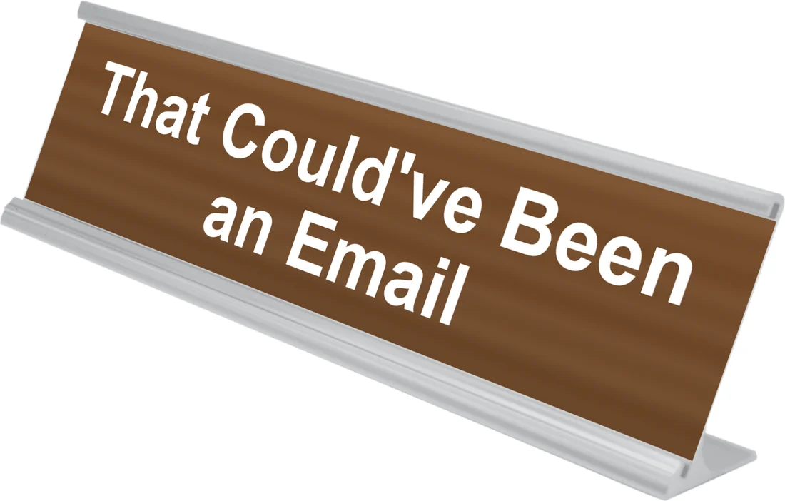 That Could've Been an Email desk plate in walnut, shown in an aluminum desk holder